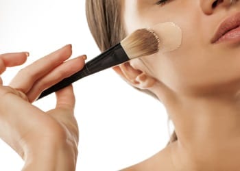 Perfectly Beautiful Always Apply Your Foundation With A Sponge A bride applying her foundation makeup with a brush